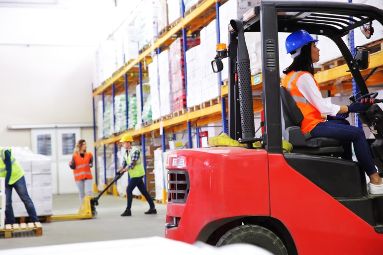 workers in warehouse wearing safety gear in order to prevent incidents