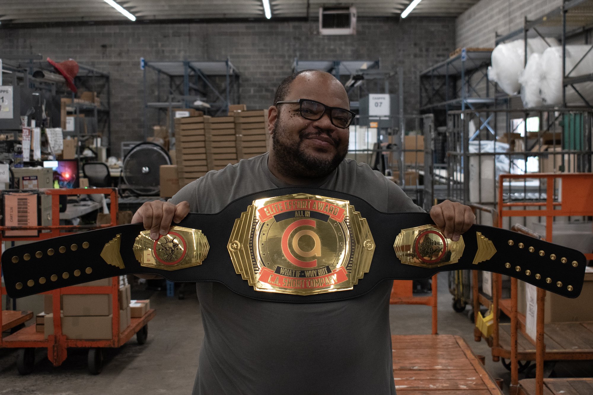 C.A. Short employee posing with awards.