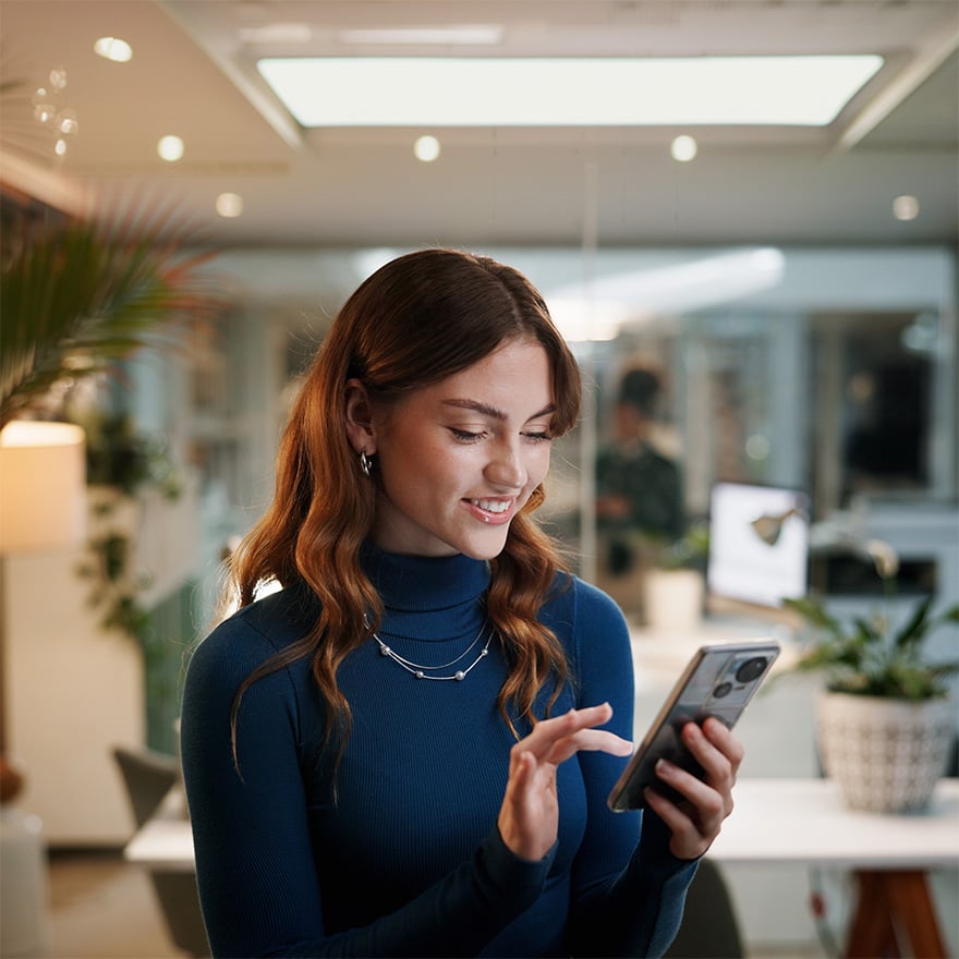 Business woman checking mobile app in her office