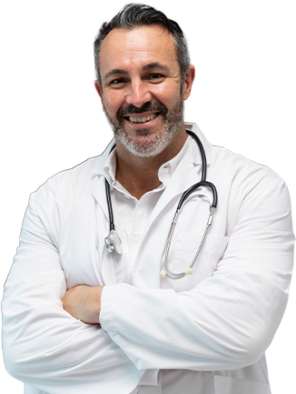 Confident physician stands smiling in a hospital hallway, representing frontline healthcare dedication-mobile