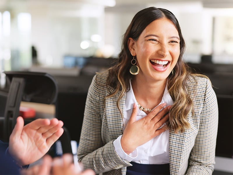 Employee laughing and feeling appreciated during a recognition moment at work