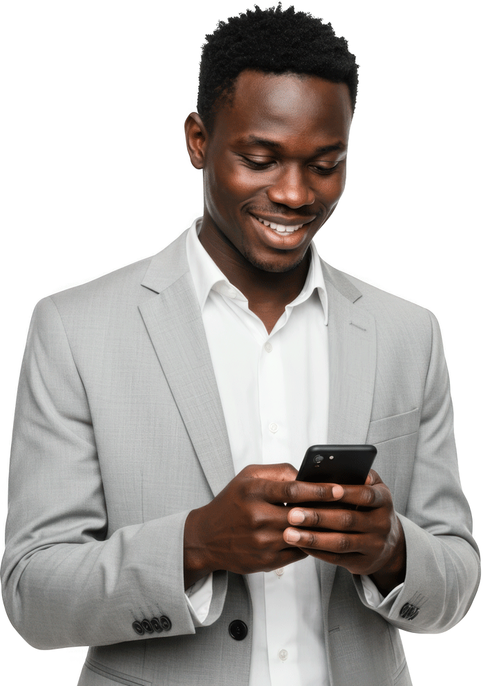 smiling young man in a light gray suit and white shirt looking down at his smartphone