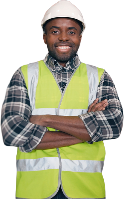 Proud warehouse worker in hard hat and safety vest standing arms crossed on the floor