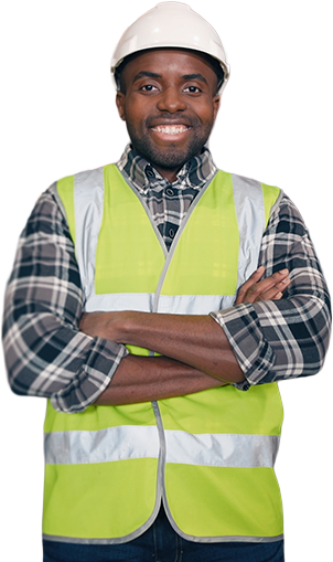 Proud warehouse worker in hard hat and safety vest standing arms crossed on the floor