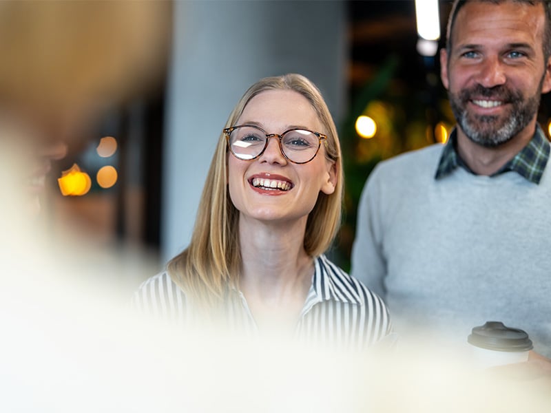 Two colleagues laughing and enjoying a positive moment together at work