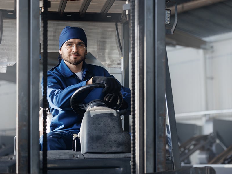 Warehouse worker operates a forklift, embodying the dedication recognition programs celebrate