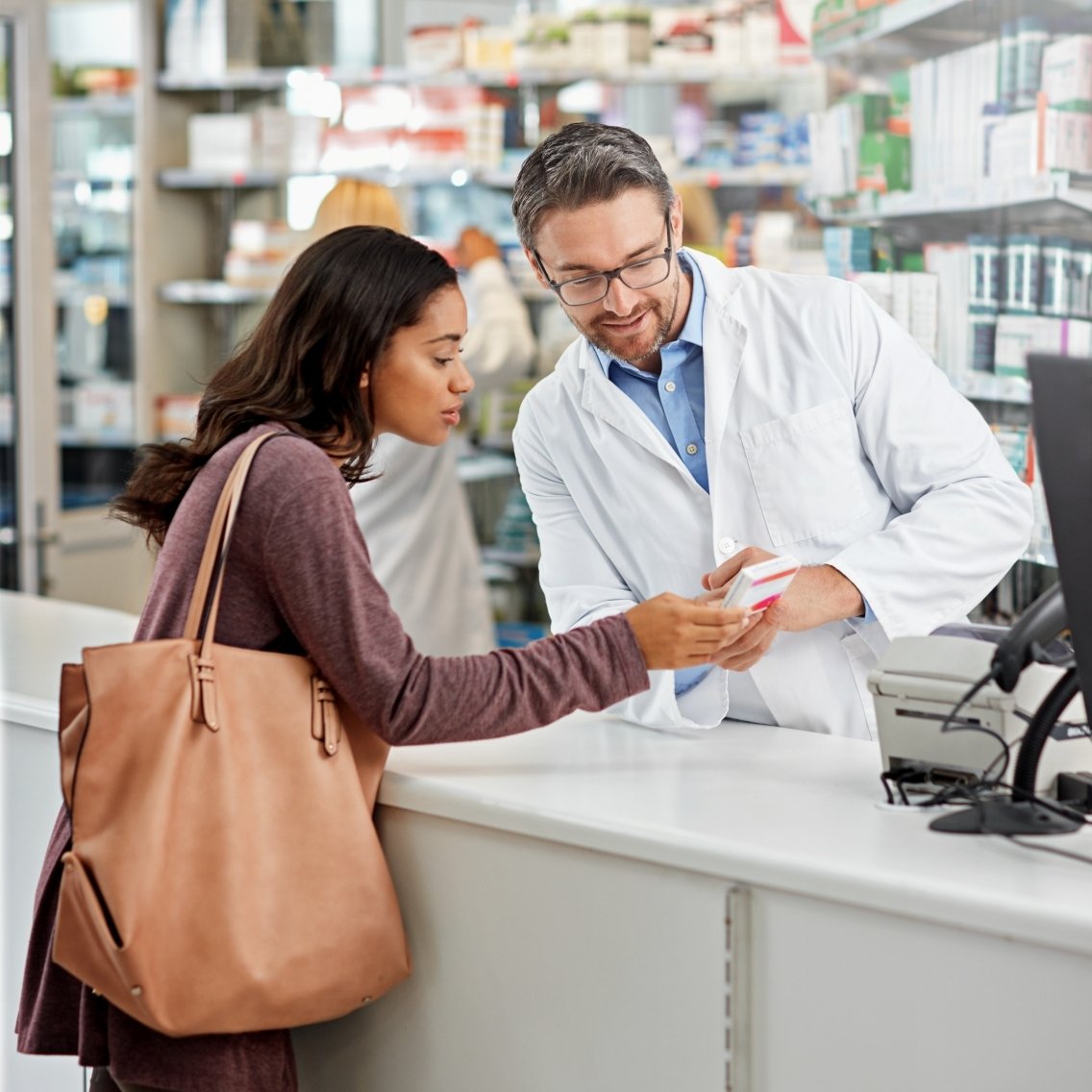 Drugstore, pharmacist and helping woman by counter