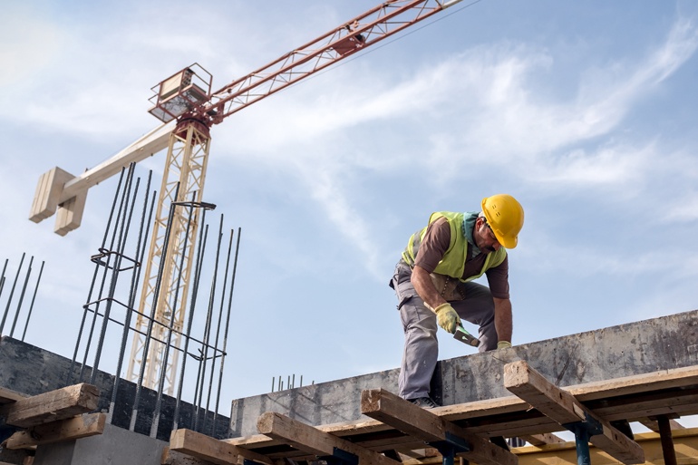 construction worker on top of building with crane over head may not be OSHA compliant