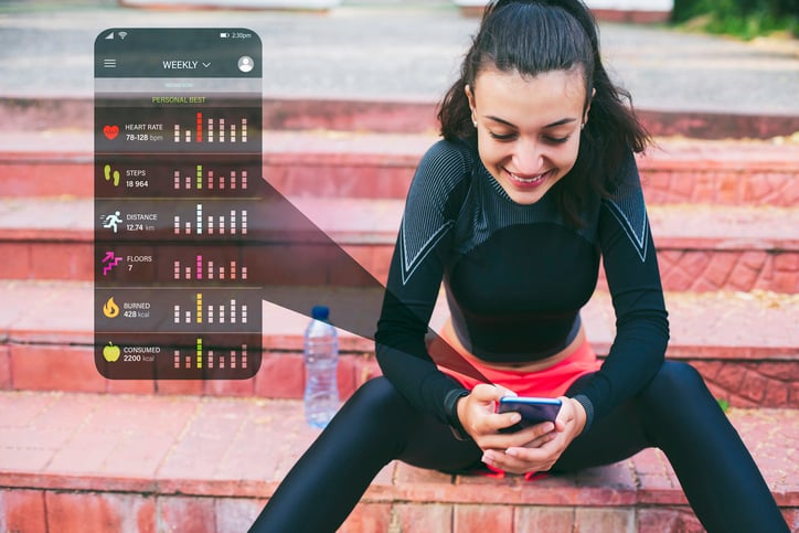 Women smiling checking data on her phone