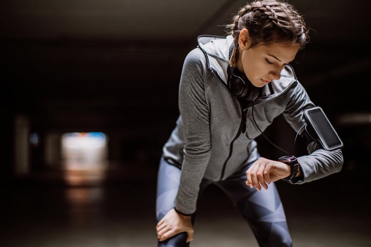A women exercising, checking her watch