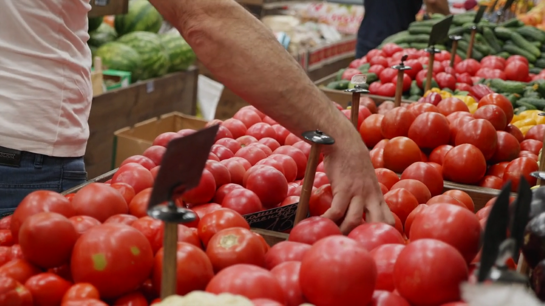 Worker Stocking Live Produce